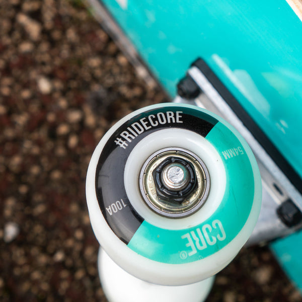Core-Complete-Skateboard-C2-Black-Teal-Wheel-Close-Up