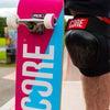 Core-Complete-Skateboard-C2-Pink-Blue-Being-Held-By-Skateboarder