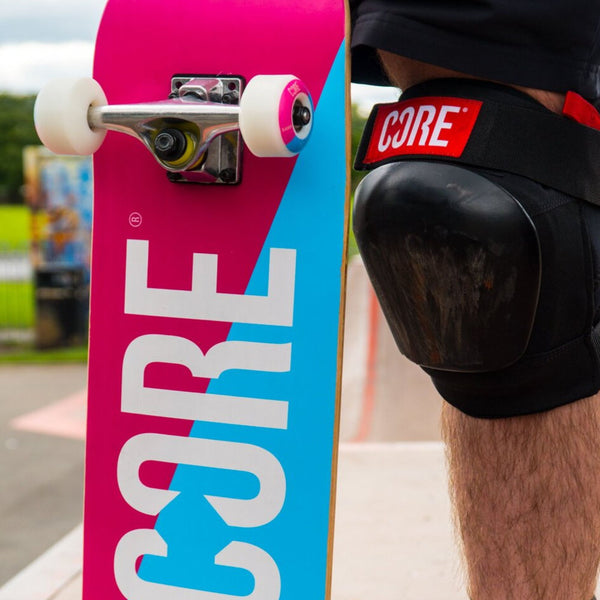 Core-Complete-Skateboard-C2-Pink-Blue-Being-Held-By-Skateboarder